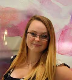 The image features a young woman with glasses, wearing a black top, posing for a portrait with a pink background.