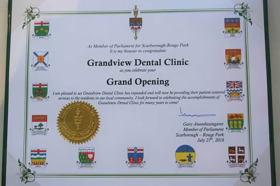 The image shows a certificate with text and various logos, including a gold seal, indicating recognition for dental services at an event named Grandview Dental Clinic.